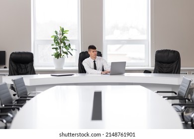 Attractive Young Man In The Office In A Conference Room Alone