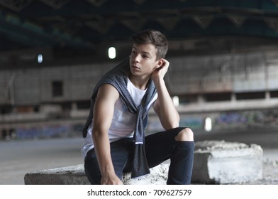 attractive young man in an old abandoned building
