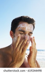 Attractive Young Man With Sunblock At The Beach