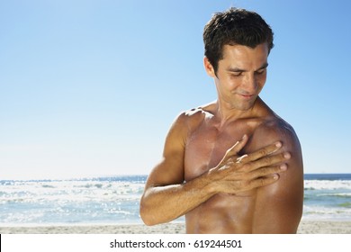 Attractive Young Man With Sunblock At The Beach