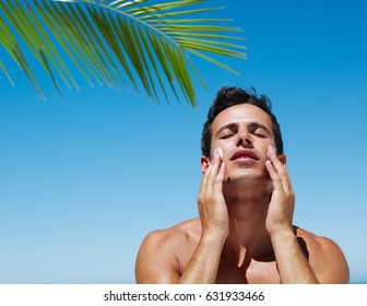 Attractive Young Man With Sunblock At The Beach