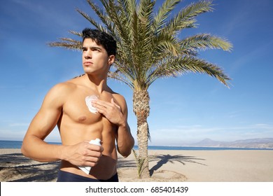 Attractive Young Man With Sunblock At The Beach