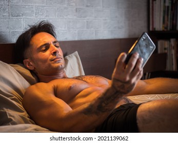 Attractive young man using cell phone to take selfie photo
