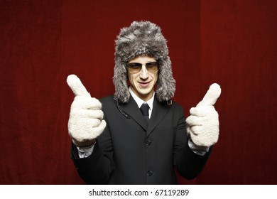 Attractive Young Man Wearing Elegant Black Suit,sunglasses And Russian Hat