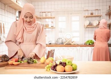 Attractive young muslim woman preparing iftar dinner together. Ramadan and eid mubarak cooking in the kitchen. Cooking and lifestyle concept - Shutterstock ID 2254782859