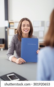 Attractive Young Office Woman Holding a Blue Folder of Documents While in a Meeting at the Boardroom. - Shutterstock ID 301920653