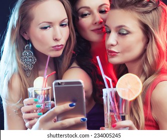 attractive young people dancing at disco and having duck face, making selfie - Powered by Shutterstock