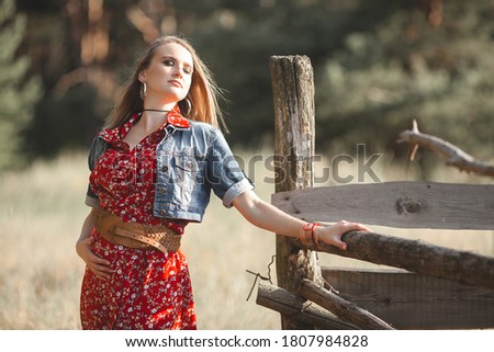 Attractive young pregnant woman country style. Female outdoors at summer