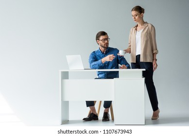 Attractive Young Secretary Passing Cup Of Coffee To Boss On White