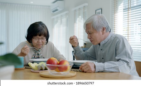 Attractive young senior asian citizen couple happy sit and talk, eat soup for healthy nutrition breakfast meal on dining table at home in morning in routine lifestyle in old asian people concept. - Powered by Shutterstock