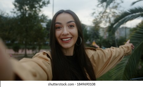 Attractive Young Smiling And Surprised Face Woman Holding Camera Or Phone In Hand And She Makes Video Call Or She Is Recording Video For Her Fans, Video Call And Vlogger Concept