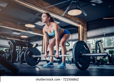 Attractive Young Sports Woman With Barbell. Deadlift.