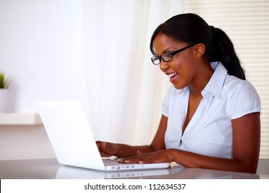 Attractive Young Woman With Black Glasses Working On Laptop At Office - Copyspace