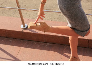 Attractive Young Woman With Broken Stiletto Heel On Her Shoe.