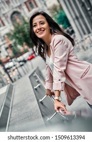 Attractive Young Woman In The City. Business Lady Is Smiling While Standing On Stairs