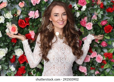 Attractive Young Woman In Classy White Dress On Flower Wall Background