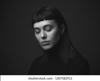 Attractive young woman with closed eyes in studio. Black and white