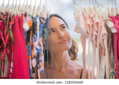 Attractive Young Woman Dreamily Looks At Things In The Store - Consumerism, Sales, Too Much Choice, Temptation And Dream Big Concepts 