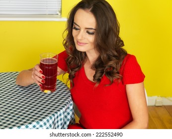 Attractive Young Woman Drinking Cranberry Juice