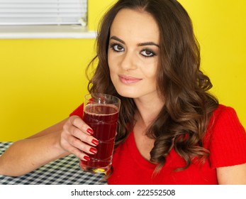 Attractive Young Woman Drinking Cranberry Juice