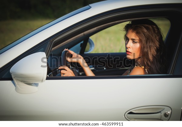 attractive young woman\
drive car summer day