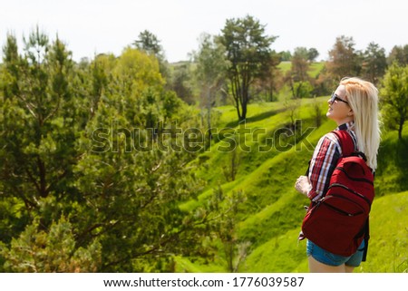 Attractive young woman enjoying her time outside in park, summer