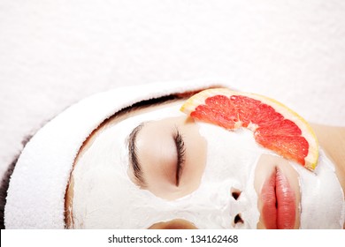 Attractive Young Woman With Fruit Mask On A Face At Spa Saloon