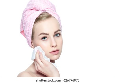 Attractive Young Woman With Her Hair Wrapped In A Towel, Removing Make Up. Pretty Girl With Perfect Complexion Cleansing Her Face Using Soft Face Wipe . Isolated On White Background With Copy Space.