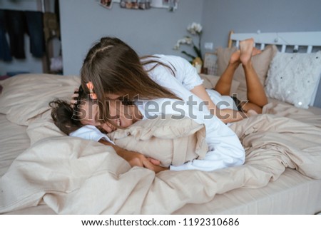 Similar – Young adult couple kissing each other on couch