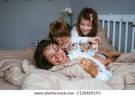 Similar – Top view of happy children having breakfast in the bed with their mother in a relaxed morning