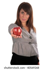 An Attractive Young Woman Hold A Red Apple, Isolated On White, With Room For Your Text. Focus On Her Hand And Apple For A Forced Perspective