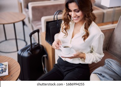 Attractive young woman holding cup of coffee and smiling stock photo - Powered by Shutterstock