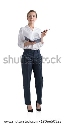 Attractive young woman is holding a notebook and pondering how to optimize business process to boost sales of the company. Full length business woman Isolated over white background