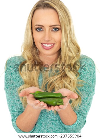 Attractive Young Woman Holding Spicy Green Chillies