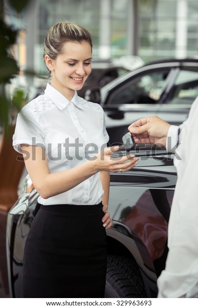An\
attractive young woman with the keys to the\
car