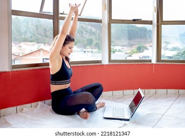 Attractive Young Woman Learning New Exercises With Online Fitness Lessons