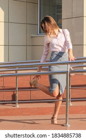 Attractive Young Woman Looking At Broken Stiletto Heel On Her Shoe.