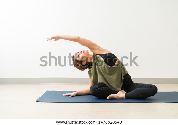 Attractive Young Woman Looking While Exercising Stock Photo Edit