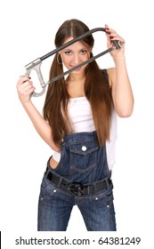 Attractive young woman in overalls holding handsaw, isolated over white background.