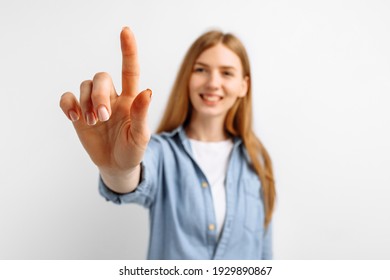 Attractive young woman pressing virtual button over isolated white background - Powered by Shutterstock
