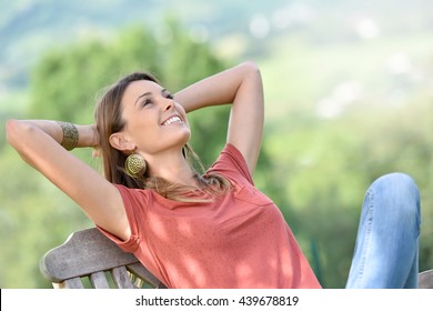 Attractive Young Woman Relaxing In Outdoor Chair