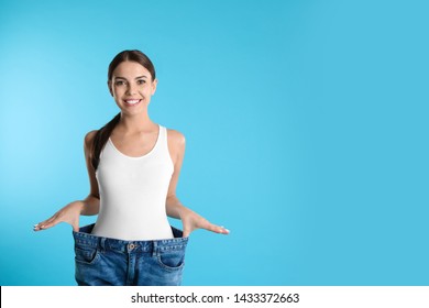 Attractive young woman with slim body wearing her old big jeans on color background. Space for text - Shutterstock ID 1433372663