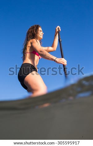 Attractive Young Woman Stand Up Paddle Boarding, Active Beach Lifestyle