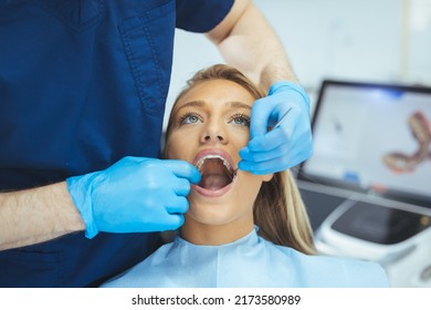 Attractive Young Woman In Stomatology Clinic With Male Dentist. Healthy Teeth Concept. Woman Visiting Her Dentist. Dentist Discussing With Smiling Female Patient