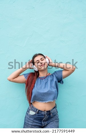 Similar – Young redhead woman listening to music