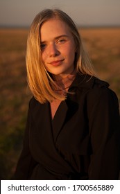 Attractive Young Woman At Sunset Outdoors. Closeup Portrait Of A Beautiful Blonde Girl With Freckles.