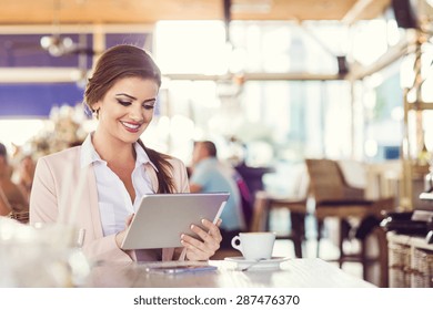 Attractive Young Woman With Tablet In Cafe