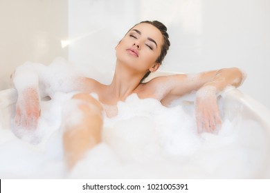 Attractive Young Woman Taking Bath With Foam At Home