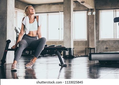 Attractive Young Woman Taking A Break After Exercise At The Gym