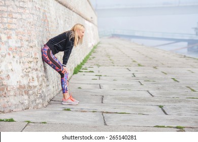 Attractive Young Woman Taking A Break From Hard Morning Workout